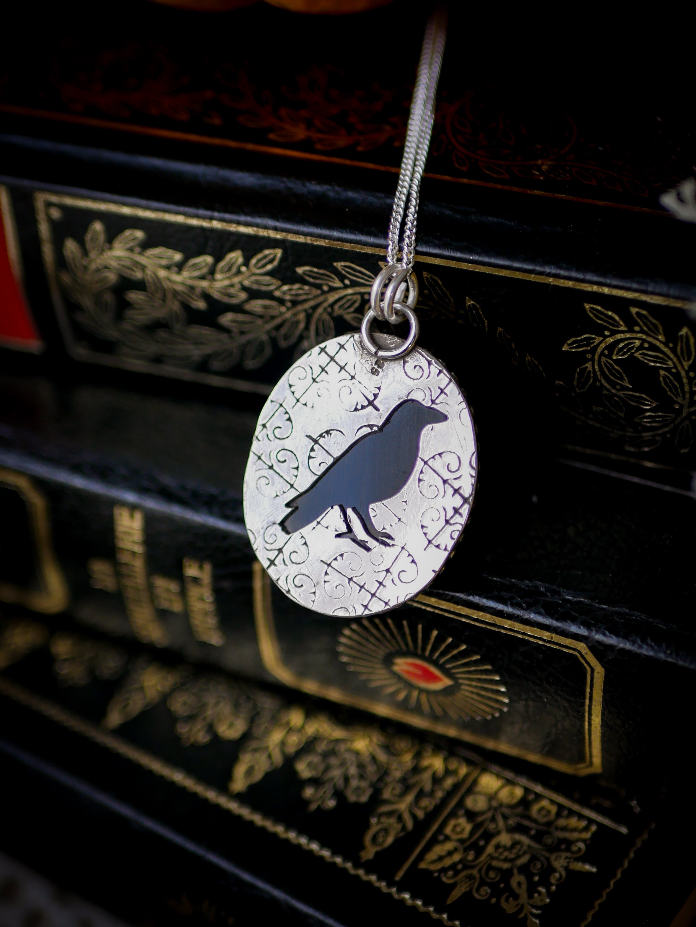 The Omen - Faceted black onyx and silver necklace, raven on the back