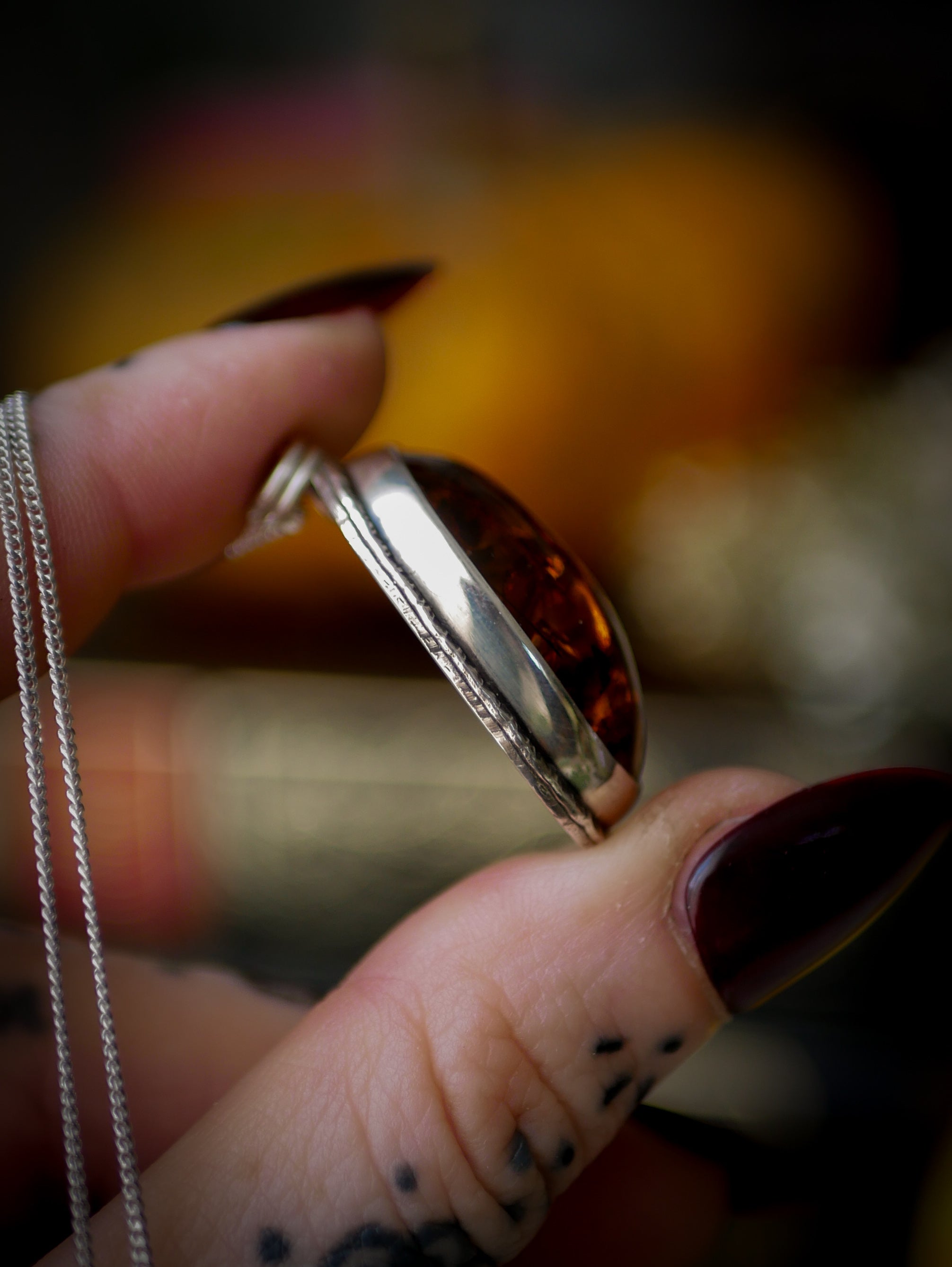 Jack O'Lantern - Baltic amber and silver necklace, Jack O'Lantern on the back