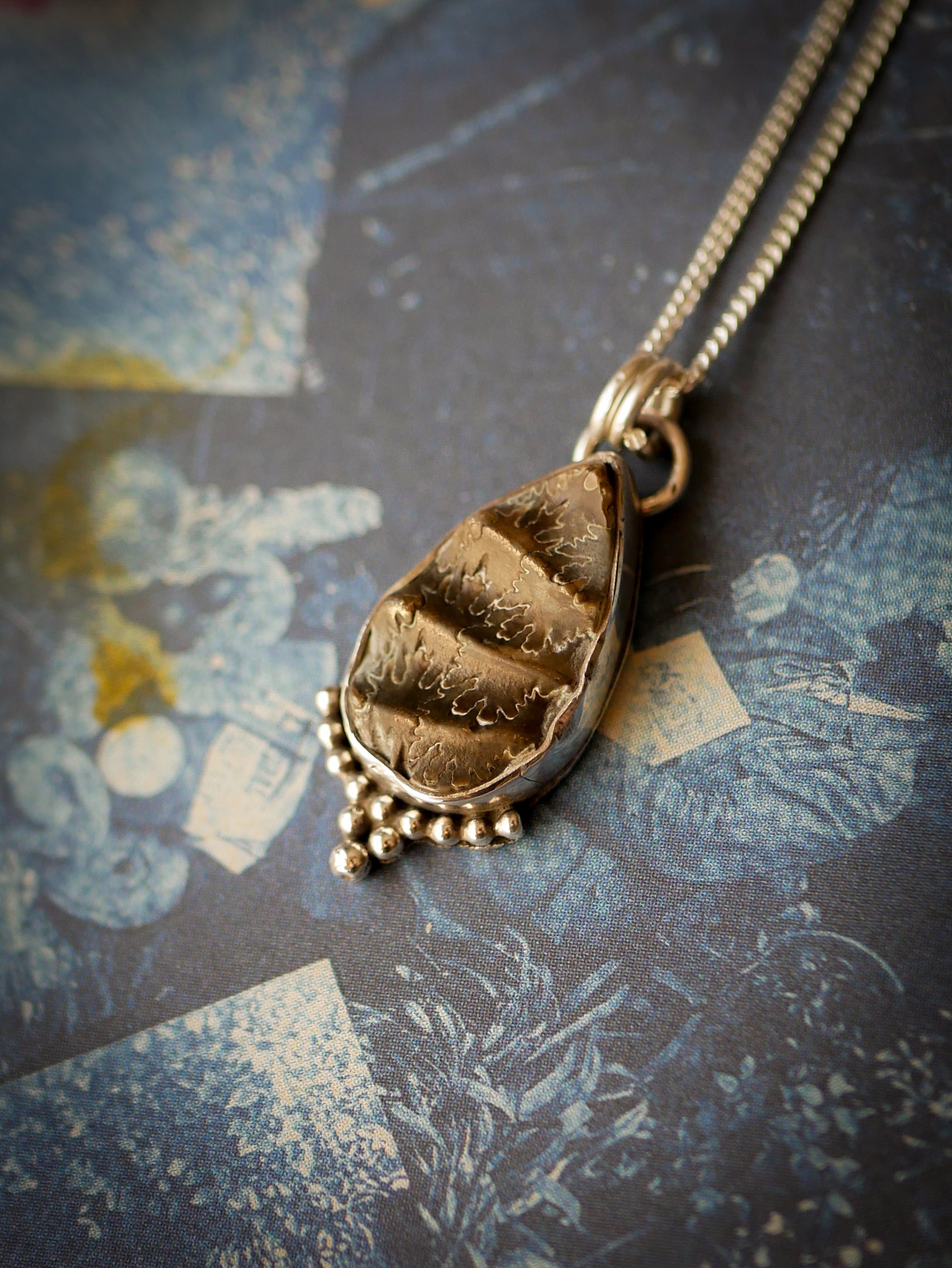 Magie Ancestrale - Collier en fossile d'ammonite et argent, étoile du Nord au dos