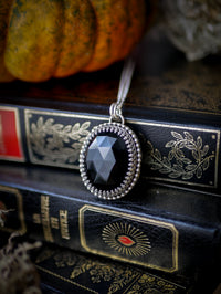 The Omen - Faceted black onyx and silver necklace, raven on the back