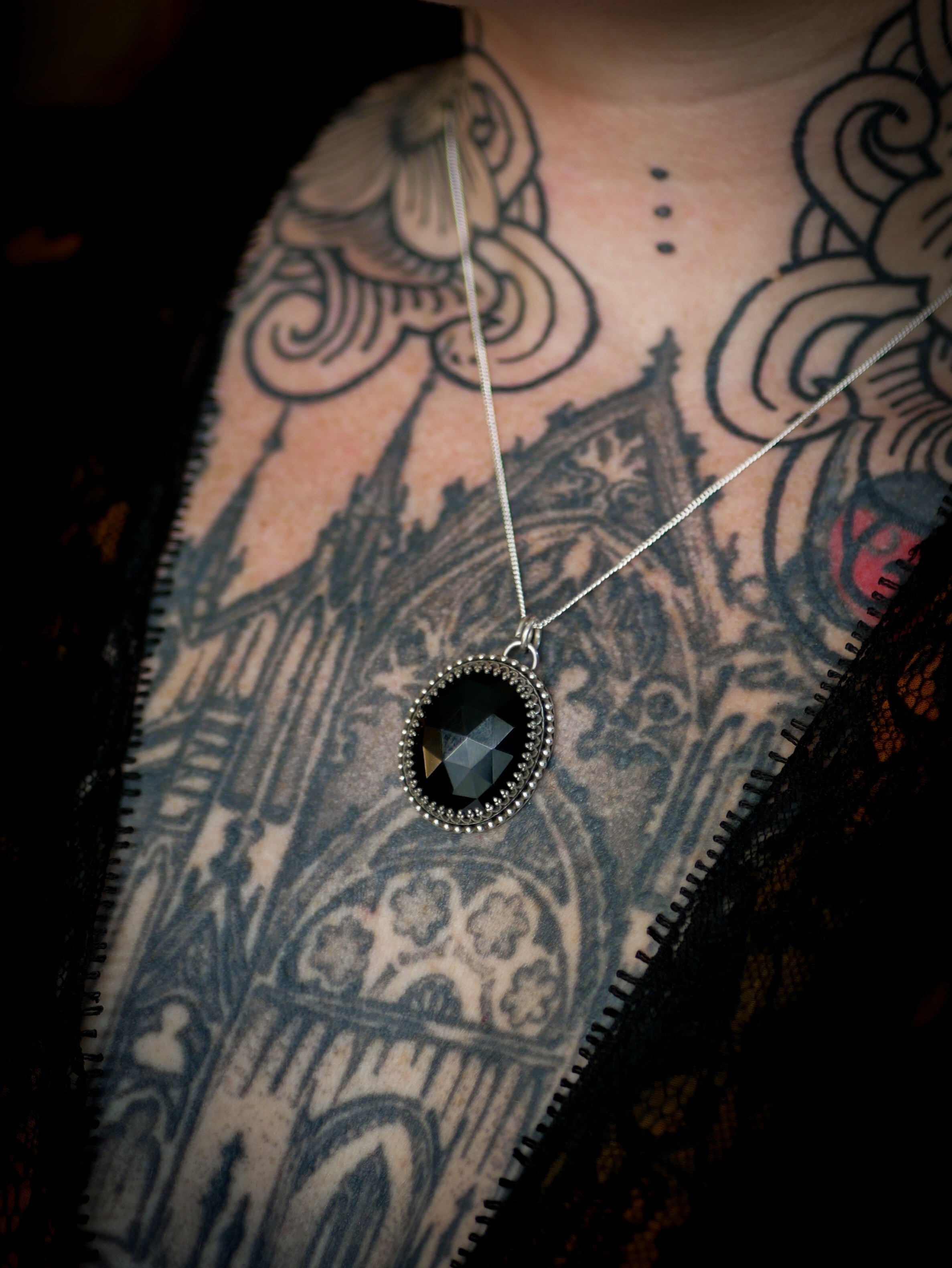 The Omen - Faceted black onyx and silver necklace, raven on the back